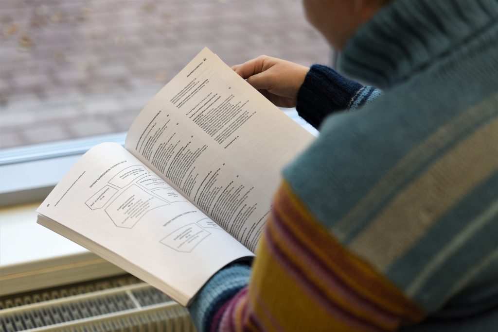 Student reading a studies manual.